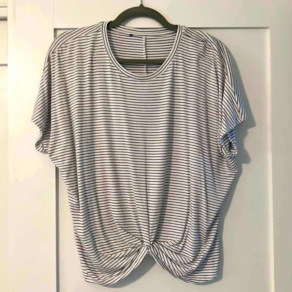 Black and white striped, beautiful drape and short sleeve. Ruching center front.
